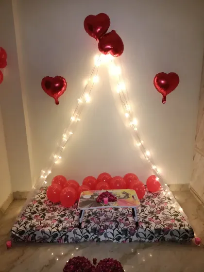 You don't need a huge budget for a beautiful surprise. This is my popular budget-friendly cabana setup, perfect for a 6-month anniversary or just a special evening, complete with fairy lights, heart balloons, and a small table for two.