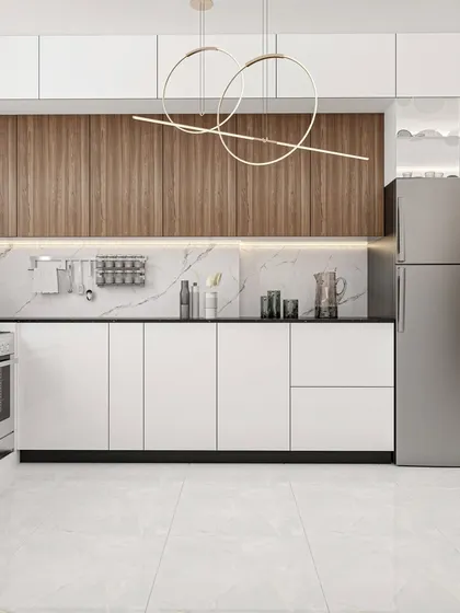 A modern kitchen design featuring a stainless steel refrigerator, sleek white cabinets, and a stylish circular pendant light fixture.