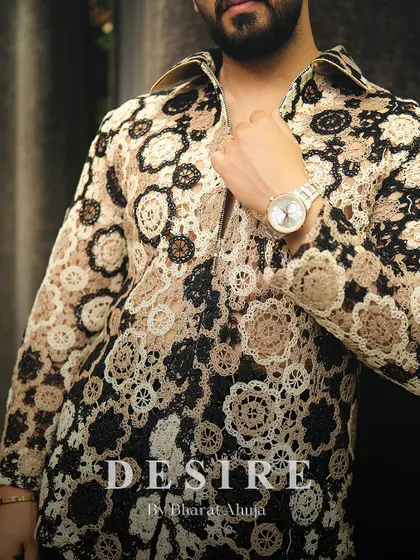 A detail shot of the crochet-style shirt, focusing on the texture and the warm, earthy color palette.