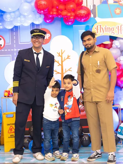 The birthday boys posing with their pilot and flight crew. Themed characters add an extra layer of fun and interaction to any kids' party.