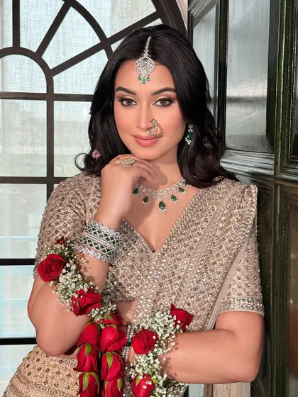 A portrait of elegance. This bride's soft glam makeup, with its neutral tones and subtle shimmer, is perfectly balanced by her statement emerald and diamond jewellery.