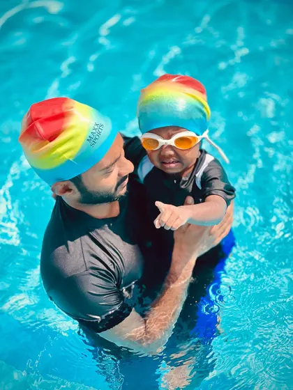 A quiet moment of connection between a coach and a young swimmer. We make sure every child feels seen and supported during their infant swim lesson.