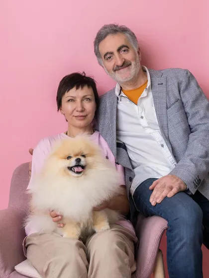 A happy family portrait from a local pet event. This couple and their smiling Pomeranian look so happy and relaxed in our pop-up studio.