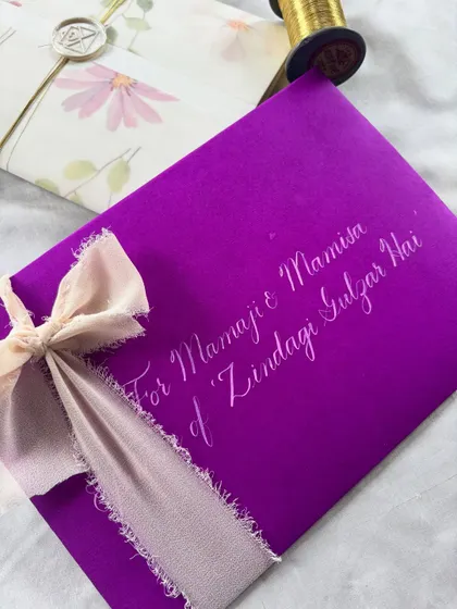 Words of nostalgia and warmth. Handwritten letters are carriers of deeply special messages. This one, with its vibrant purple envelope and silk ribbon, was curated with intention to remind the reader how important they are.
