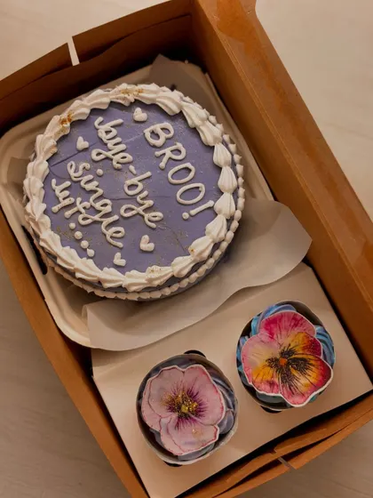 Say "bye-bye single life" with this fun bachelorette or bridal shower combo. The lavender-colored bento cake is paired with two cupcakes decorated with beautiful, edible painted flowers.
