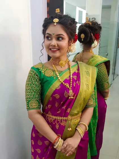 This image captures the full traditional attire for our Gudi Padwa shoot, showing how the makeup complements the bright colors and gold jewelry.