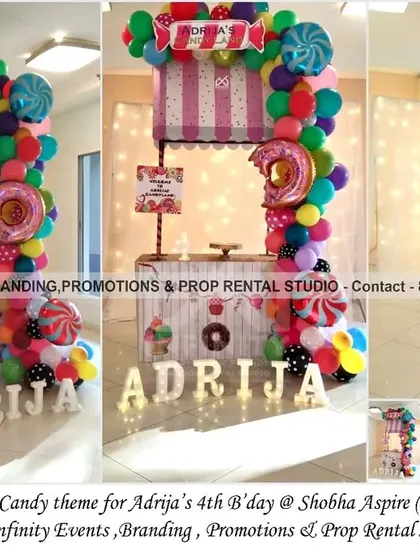 A simple and elegant mini candy cart for a 4th birthday at Shobha Aspire. This setup is perfect for smaller spaces, featuring a striped awning, a colorful balloon garland, and light-up letters for a fun and sweet celebration.