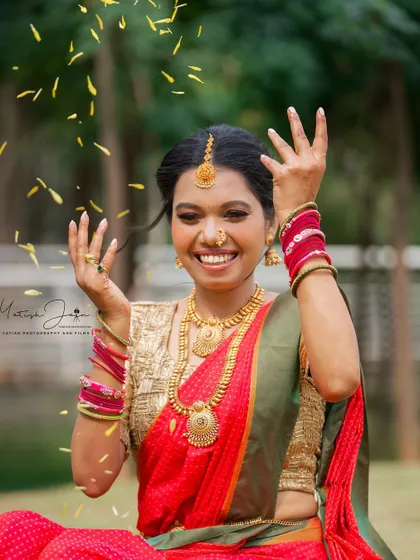 A happy, candid moment celebrating the festival. The makeup is fresh and glowing, capturing the joy of Ganesh Chaturthi.