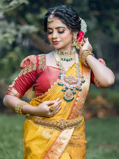 A closer view of the bridal ensemble, showcasing the detailed embroidery on the puff sleeves and the traditional jewelry.
