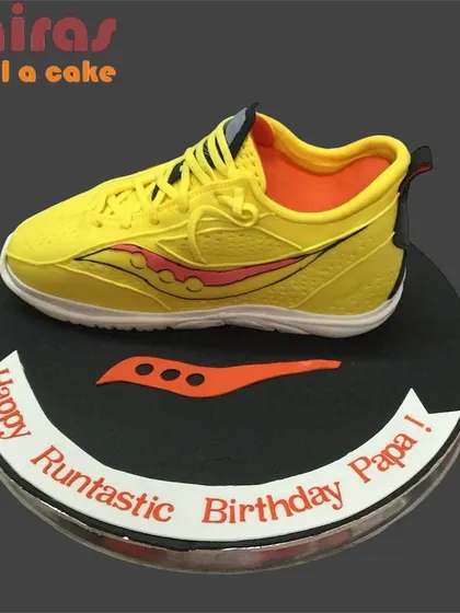 A "runtastic" birthday cake for a dad who loves to run. This cake is topped with a realistic, sculpted running shoe, making it a perfect and personal gift for a fitness-loving parent.