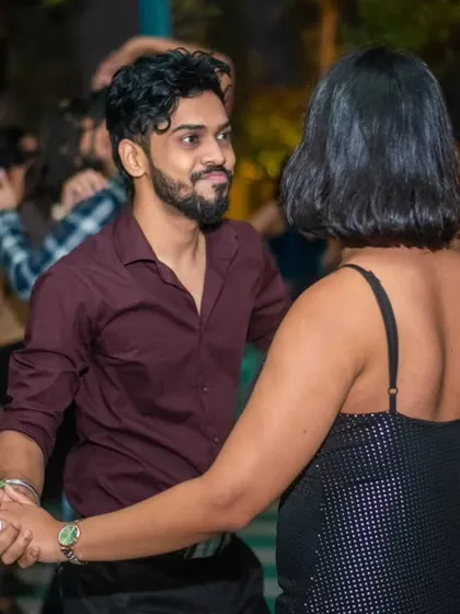 A classic dance hold, with both partners focused and connected.