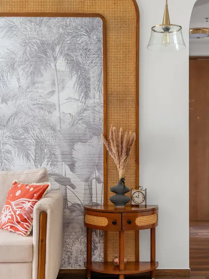A close-up of the cane detailing and monochromatic wallpaper that ties the entire room together with warmth and elegance.
