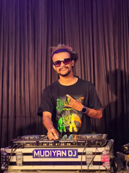 Posing for a quick photo at the DJ booth during a break in a lively wedding party.
