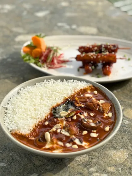 A satisfying bowl of Massaman curry with rice, a perfect meal for one.