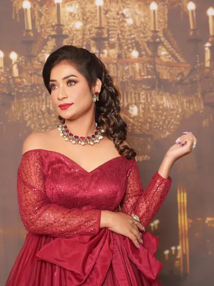 A full-length view of this stunning red gown look. The makeup was designed to complement the drama of the outfit, with a focus on glowing skin and classic glamour, ensuring the client felt absolutely radiant.