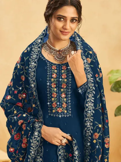 A classic blue salwar kameez with a beautifully embroidered floral dupatta. It's a versatile piece that can be dressed up or down for any event.