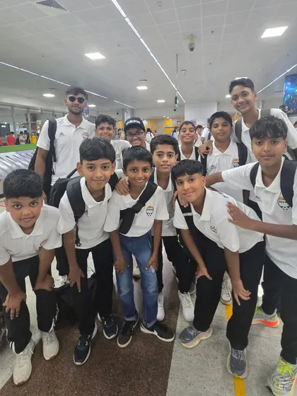 A group of our younger players with their coach at the airport, full of energy.