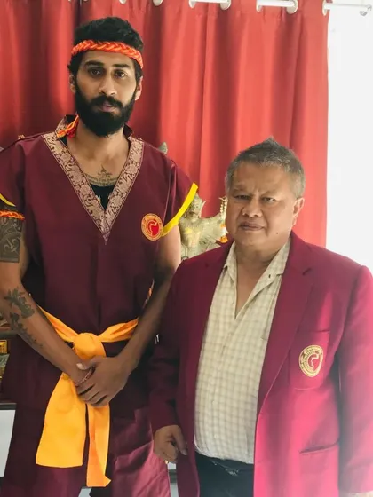 With my master in traditional Muay Boran attire. It is an honor to carry on the ancient lineage of this martial art.