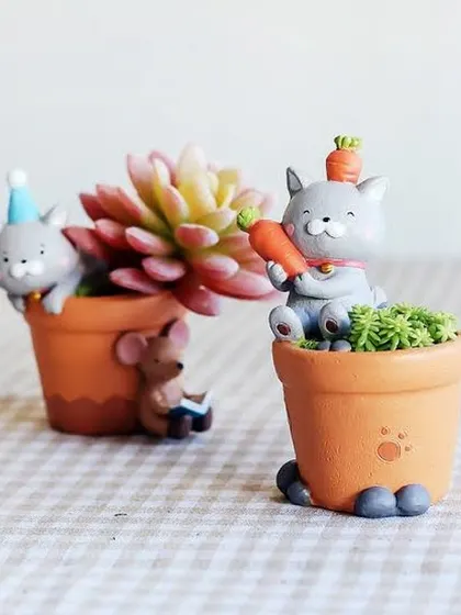 Our collection of toy pots includes these adorable cat-themed planters. They are perfect for tiny succulents and bring a smile to your face.