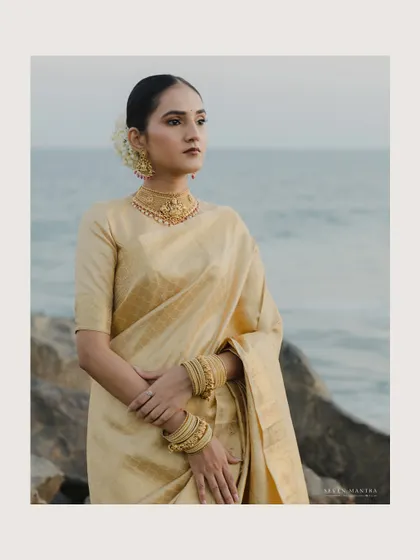 A portrait of poise by the sea. The bride's gaze towards the horizon and the soft colors of the sky and water create a serene and contemplative mood.