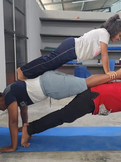 This three-person plank stack is a fantastic display of teamwork and progressive strength.