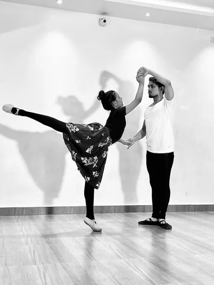 A black and white series featuring a male and female ballet dancer (ballerino and ballerina) practicing partner work. My classes include pas de deux techniques for advanced students.
