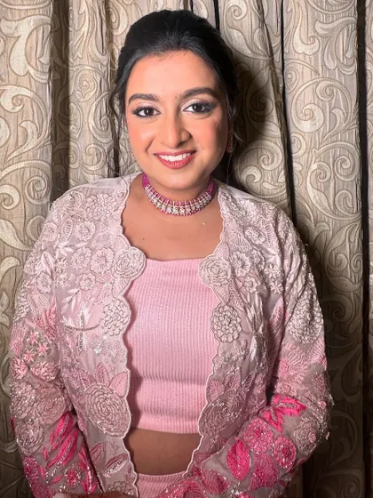 The client looking pretty in pink, her sparkling ponytail completing the look.