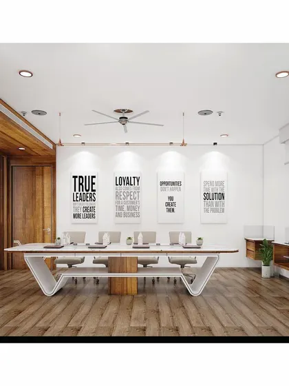 Another view of the boardroom, emphasizing the spaciousness and the combination of wood flooring with white walls. The layout is designed to facilitate communication and decision-making.
