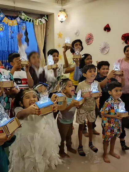 That proud "I made this" feeling is what we're all about. A group of happy inventors shows off the personalized light-up lamps they designed and wired themselves, a perfect party favor to take home.
