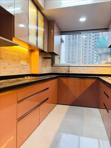Another look at the U-shaped kitchen, showing the ample storage provided by the full-length cabinets.