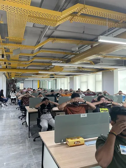 Yoga doesn't always require a mat. This is a chair yoga session in a typical office setting, where we are practicing techniques to release tension directly at the workstation. These sessions are designed for convenience and maximum impact on employee well-being.