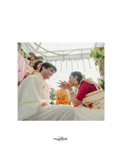 An intimate moment during a traditional ceremony, capturing the playful interaction between the bride and groom.