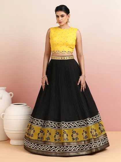 The full view of the black and yellow lehenga, showcasing its elegant silhouette and striking color contrast. It is perfect for an evening reception or festive party.