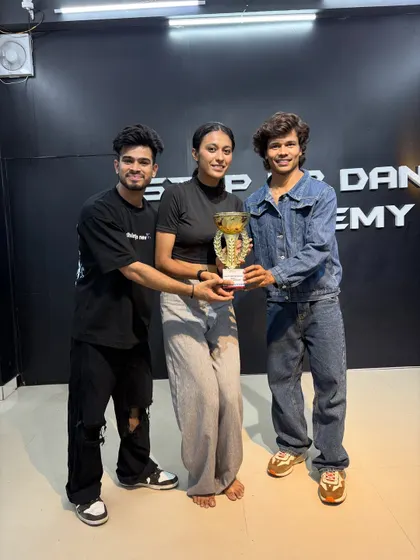 Proud to see our student holding her trophy. Our training focuses on perfecting technique and stage presence for dance competitions.