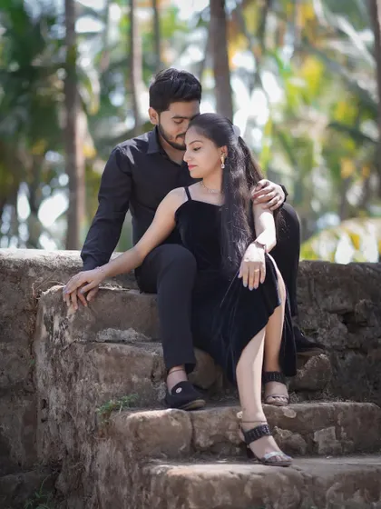 A romantic pose on the steps of the old fort. The contrast of their modern black outfits with the rustic setting is very striking.