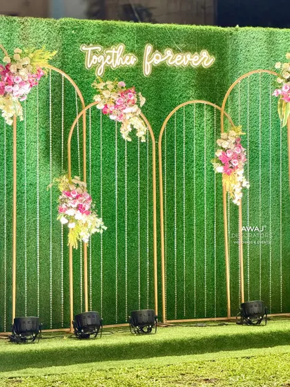 A "Together Forever" neon sign against a green hedge wall, a modern and romantic backdrop for a photo op.