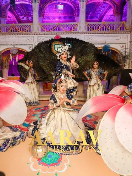 A stunning Raasleela performance at Chomu Palace. An artist dressed as Krishna is framed by a backdrop of real peacock feathers, with dancers creating a beautiful formation around him.