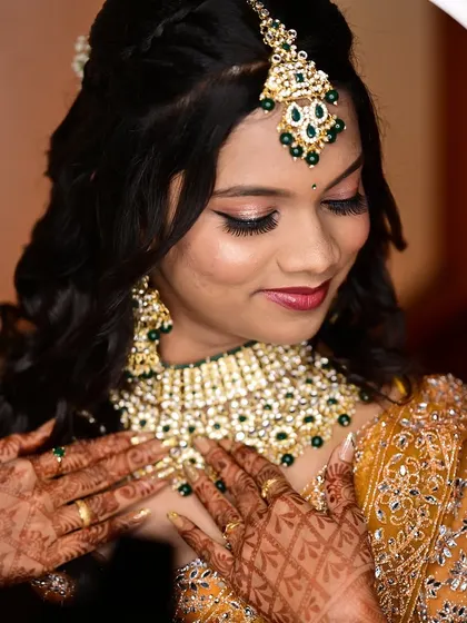 A close up of the bride's reception makeup, framed by a ring light. The focus is on the shimmery eye makeup and flawless skin.