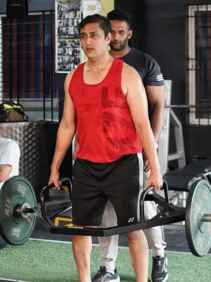Spotting a client during a heavy trap bar deadlift. My job is to ensure you can push yourself to the max while maintaining safe and effective form.