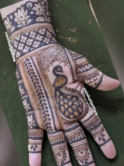 A bold peacock design on the back of the hand. The use of negative space makes the peacock the star of the show.