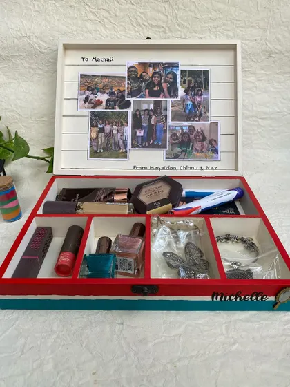 The inside of this personalized organizer box features a photo collage of special memories, making it a truly heartfelt gift. The compartments help keep makeup and jewelry tidy.