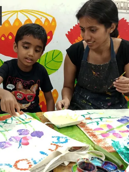 I love providing personalized guidance to help a child's vision come to life. Here, a student gets a little help with her vegetable printing technique, ensuring she feels successful and proud of her work.