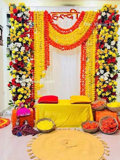 A wider view of the corridor Haldi setup, showing how all the elements come together to create a festive atmosphere in a compact space.