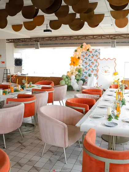 Another perspective of the chic baby shower venue, showing the beautiful harmony between the themed decor, the modern furniture, and the airy, light-filled space.
