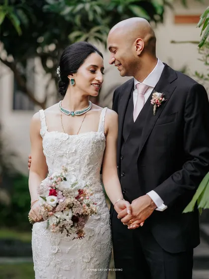 A beautiful portrait of Priya and Matthew after their wedding. Her elegant gown and his classic suit, combined with their loving gaze, create a picture of timeless grace.