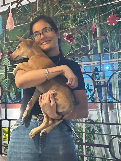 A participant in Kolkata shares a warm hug with a happy indie pup. Our art sessions at Mrs. Wilson's Cafe provide a cozy, intimate setting for people to bond with shelter animals.