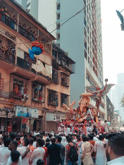 A view of the Ganpati procession from a high angle, showing the scale of the crowd and the idol. The entire city comes together for this grand farewell.