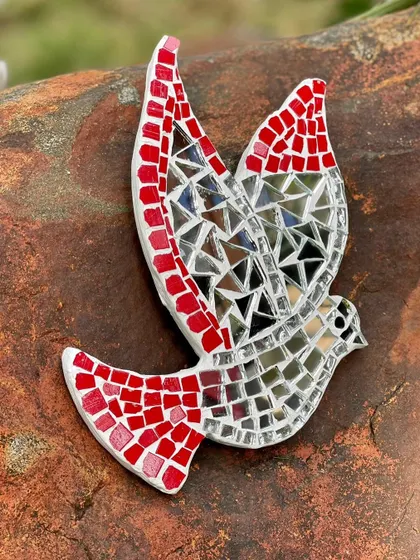 Another view of the mosaic bird wall hanger. The combination of hand-cut ceramic tiles and mirrors creates a beautiful, reflective piece of art that brings light and freshness to your space.