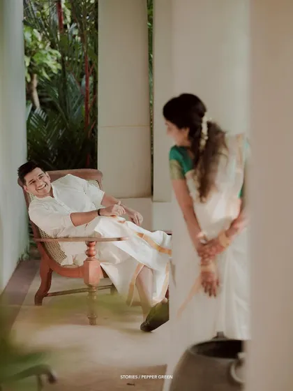 A quiet, stolen moment between Jayaram and Abirami. The soft lighting and their relaxed poses give this image a very natural and serene feel.