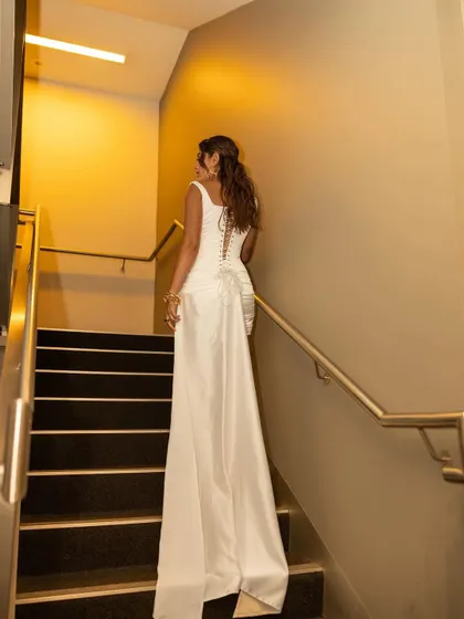 An exit as dramatic as the entrance. The train of Lisa's white dress cascades beautifully as she walks, creating a final memorable moment.